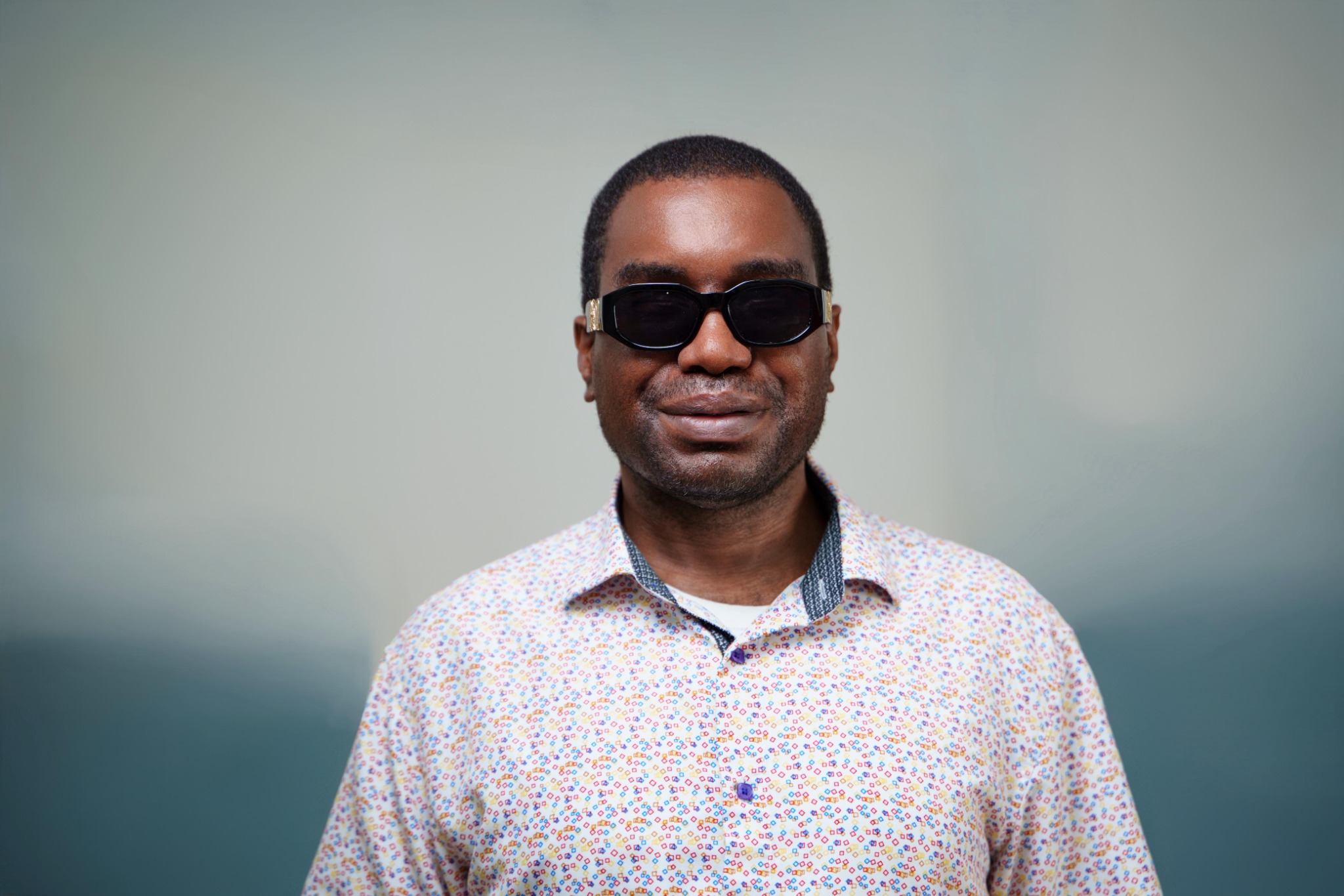 Close-up professional head-and-shoulders portrait of Kevin E. Cartwright smiling gently toward the camera.